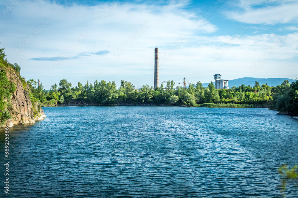 Forest lake under blue cloudy sky. Forest lake under blue cloudy sky.