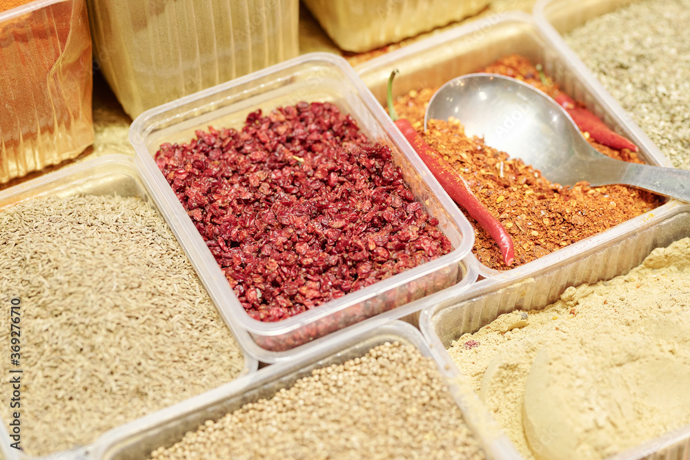 Close-up of various spices in disposable containers used for cooking savory dishes at food market Close-up of various spices in disposable containers used for cooking savory dishes at food market