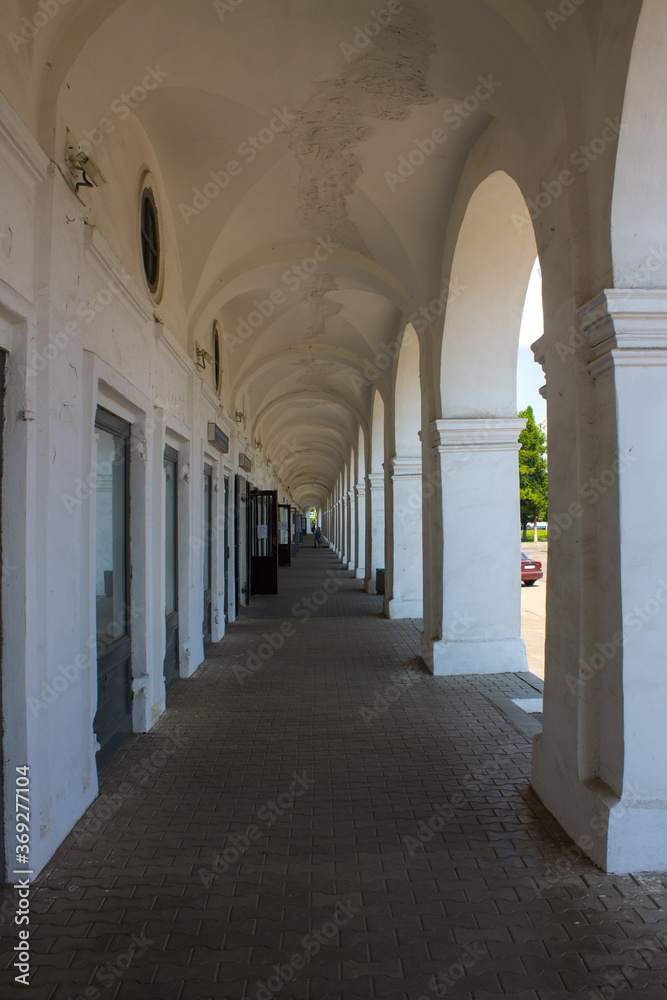 Old colonnade in the red rows of shopping malls in Kostroma Russia close up
