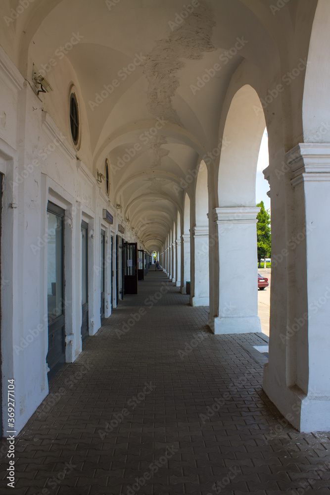 Fototapeta premium Old colonnade in the red rows of shopping malls in Kostroma Russia close up
