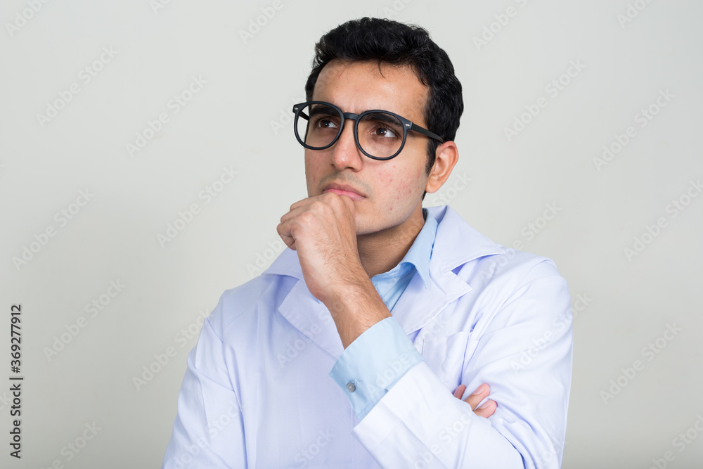 Portrait of young handsome Indian man doctor Portrait of young handsome Indian man doctor