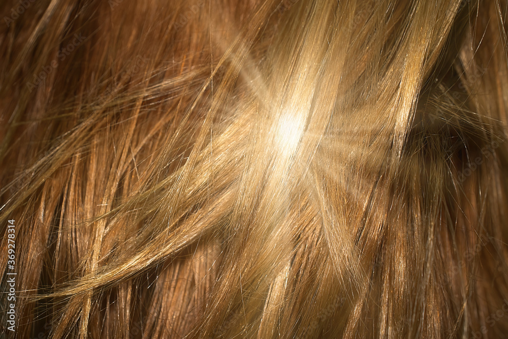 Naklejka premium Brown shiny hair as background. Sun flare