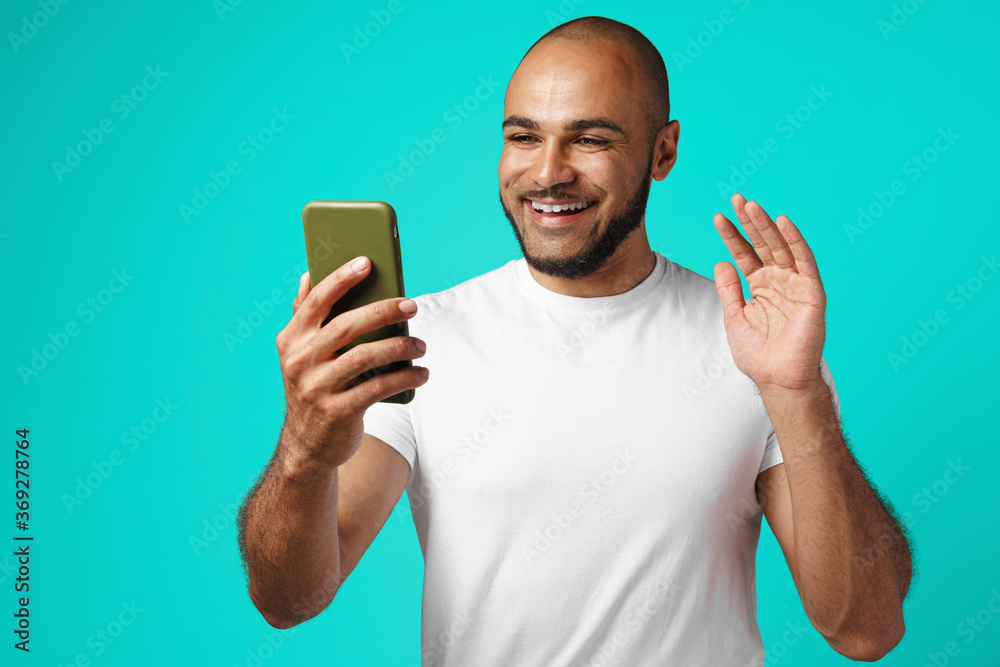 Young african american man making video call with his smartphone Young african american man making video call with his smartphone