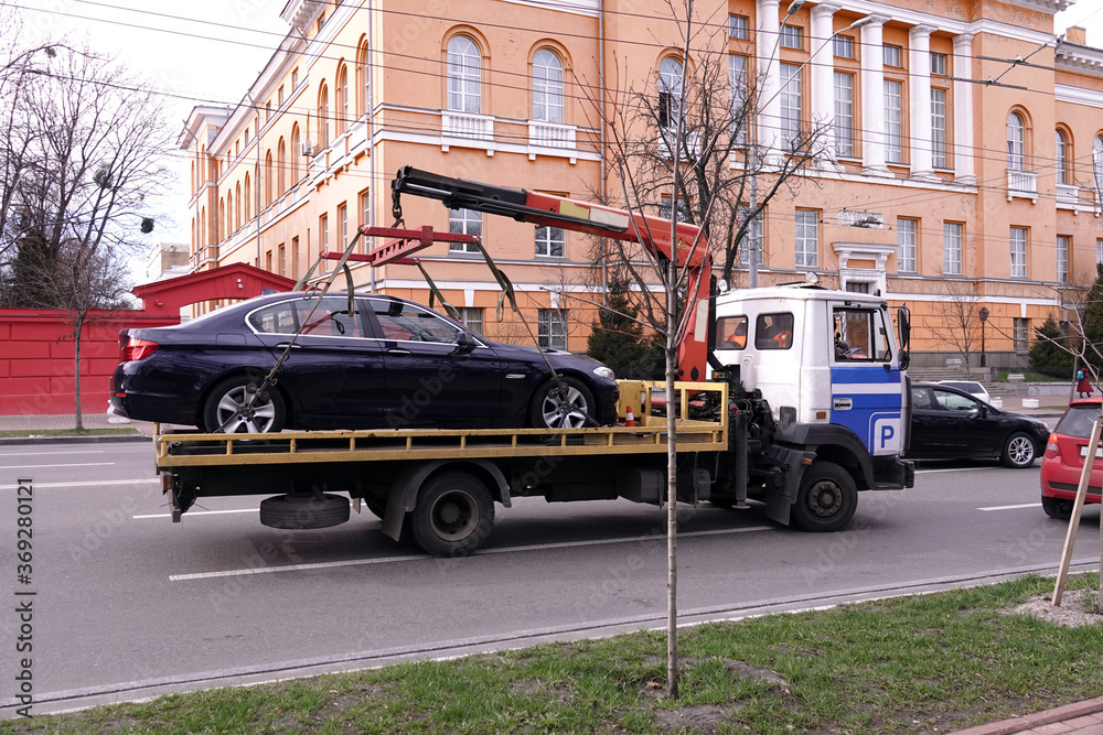 Fototapeta premium Tow truck takes the car off the road