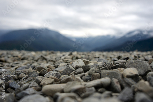 stones on the background of a mountain landscape. gray sky with clouds
