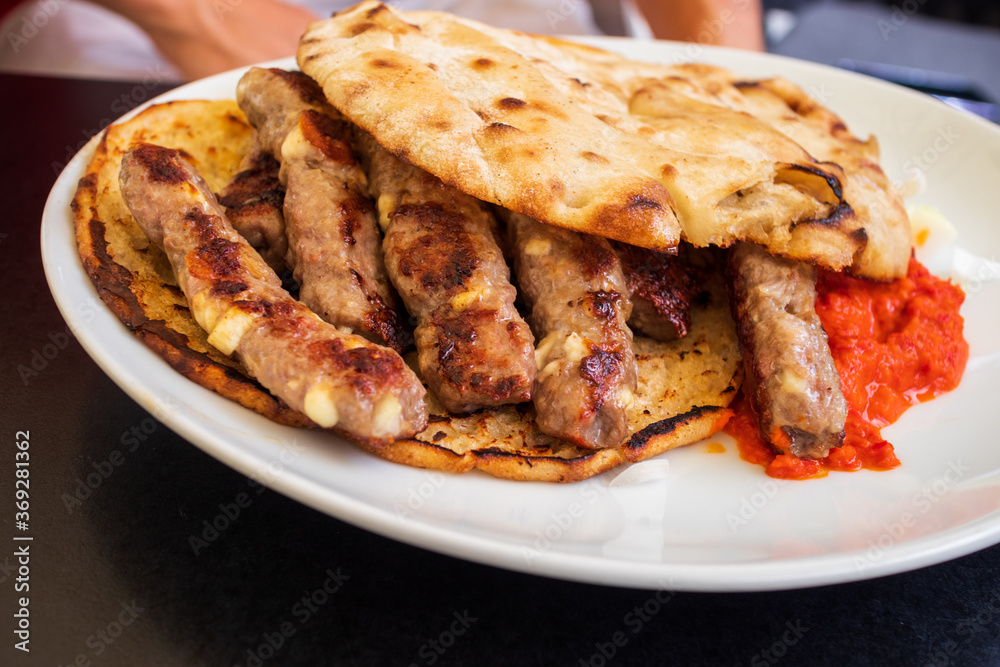 Cevapcici or Cevapi, Bosnian dish prepared on the barbecue and served with Lepinja bread. Popular Balkan dish.