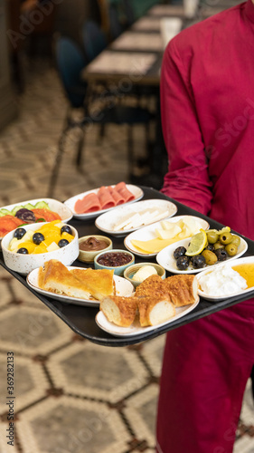 Fototapeta Naklejka Na Ścianę i Meble -  Waiter holding breakfast food on plate