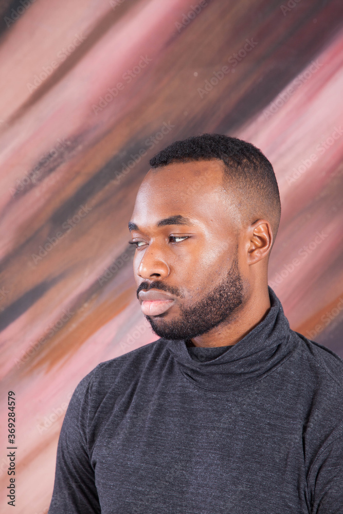 Fototapeta premium Handsome Black man looking Pensive in a grey shirt