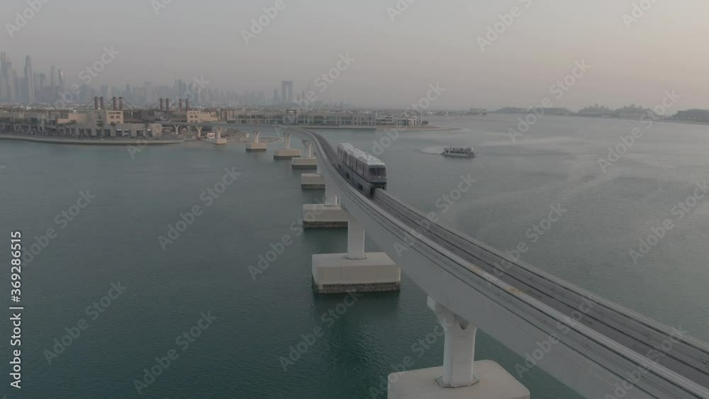 Drone video shot of tram passing on Dubai Mono rail bridge, Palm Jumeirah monorail train Drone video shot of tram passing on Dubai Mono rail bridge, Palm Jumeirah monorail train