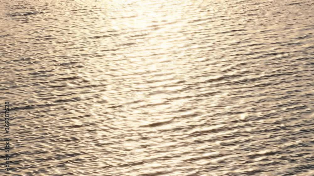 Surface of the water gold surface and sunlight at sunset on the river. water nature background Surface of the water gold surface and sunlight at sunset on the river. water nature background