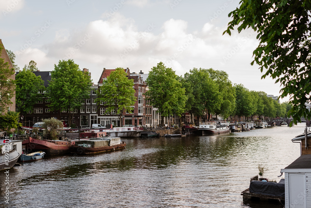 View of colorful dutch houses on the water channel of Amsterdam.