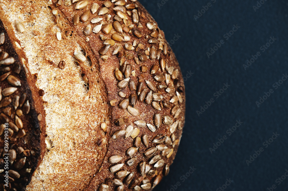Sunflower Seed Artisan Loaf of Bread on Black Background with copy space Sunflower Seed Artisan Loaf of Bread on Black Background with copy space