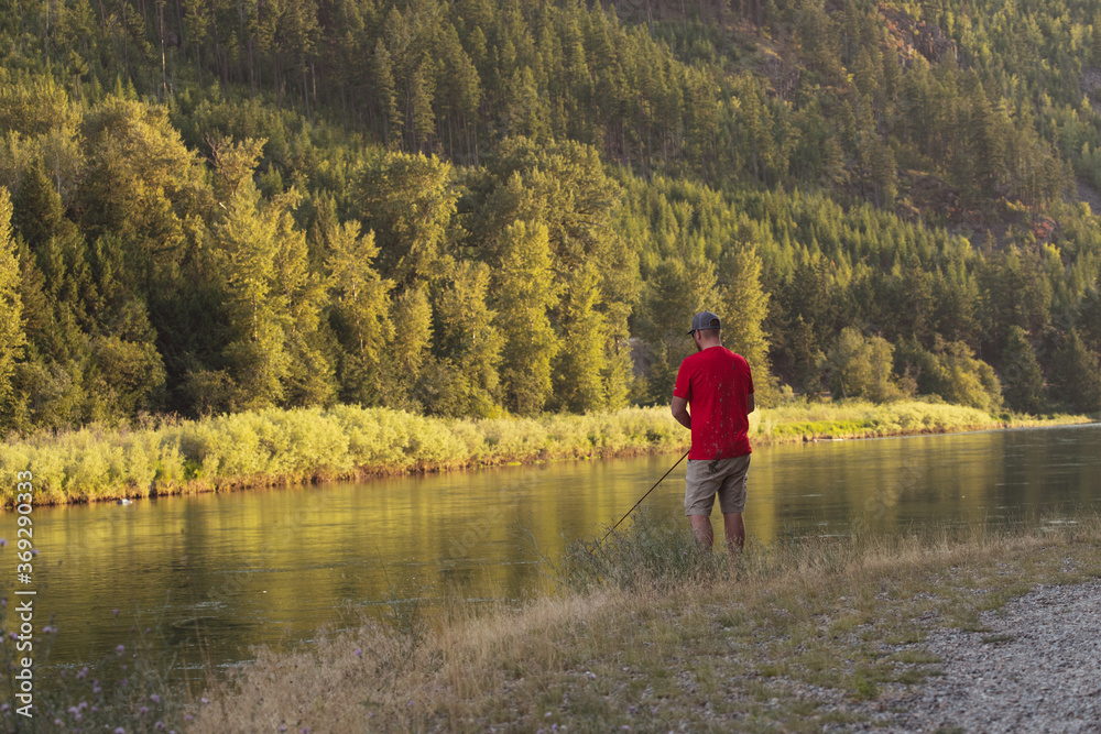Man fishing on river bank Montana 