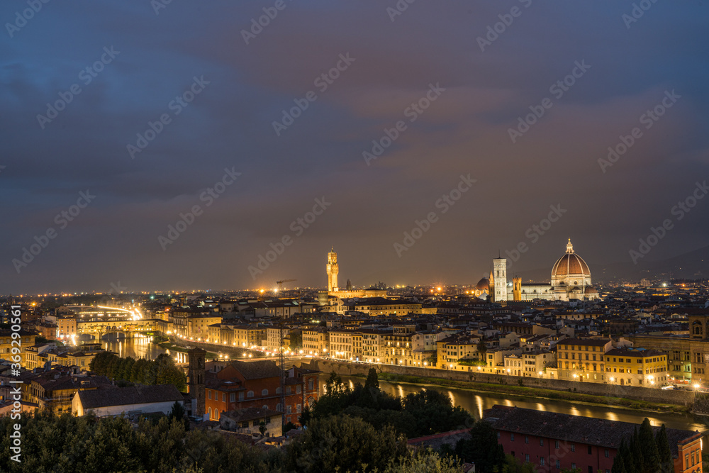 Florence old city skyline at night with Ponte Vecchio over Arno River and Cathedral of Santa Maria del Fiore in Florence, Tuscany, Italy.