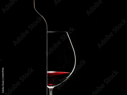 Silhouette of wine glass and bottle on black background