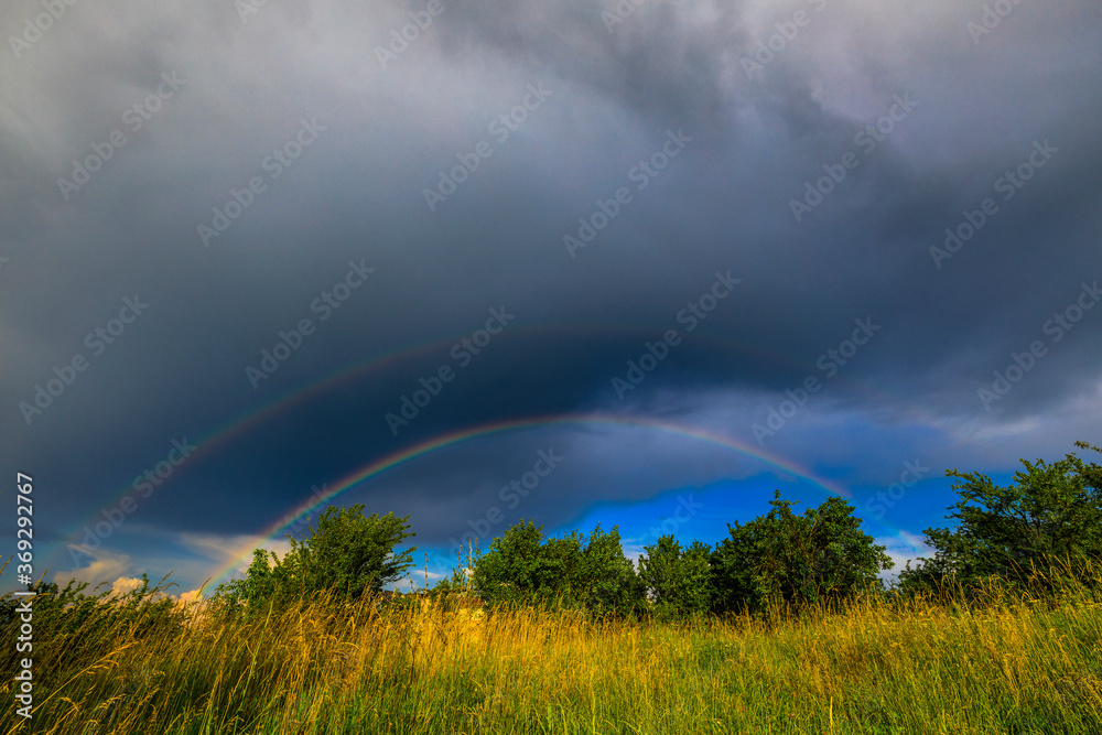 A beautiful rainbow in the mountain landscape. A beautiful rainbow in the mountain landscape.