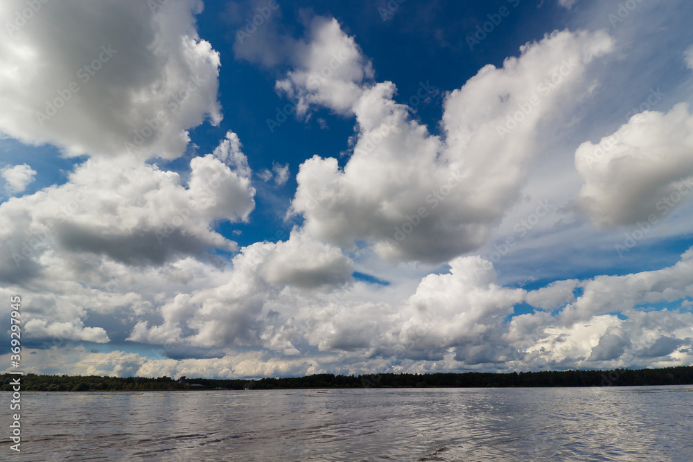 Blue sky and white clouds over the river