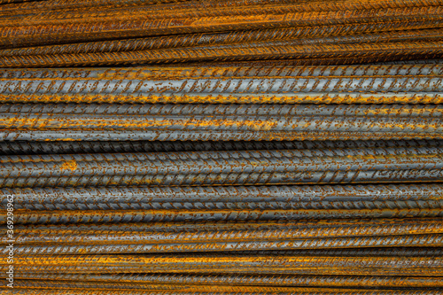 Rusty steel rods. Material for the construction of buildings and houses. Strong metallic material forming a repeating pattern