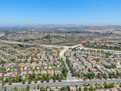 Aerial view of middle class subdivision neighborhood with residential villas and mountain on the background in San Diego County, California, USA. © Unwind