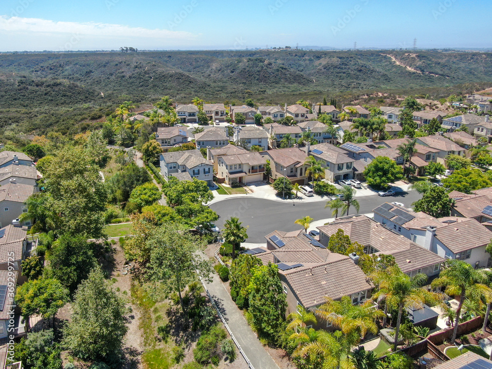 Aerial view of middle class subdivision neighborhood with residential villas next to each other in San Diego County, California, USA.