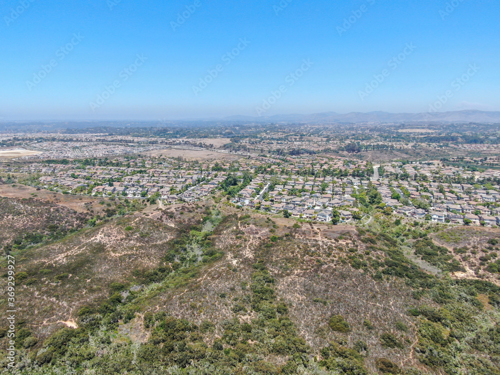 Aerial view of Los Penasquitos Canyon Preserve with Torrey Santa Fe middle neighborhood with residential villas in San Diego County, California, USA.