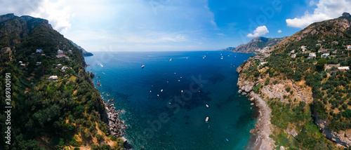 Aerial wide view panorama of Laurito, Positano - popular tourist destination in Italy. Sunny summer day. Copy space, clear sea and green mountains of Sorrento. Travel and vacation. © Sergey