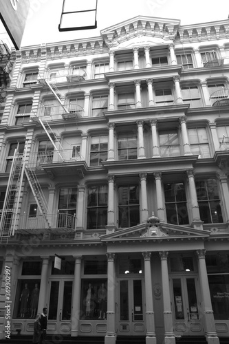 Beautiful Old Apartment Building Exterior with a Fire Escape in black and white, monochrome in Manhattan, New York City, USA, America.