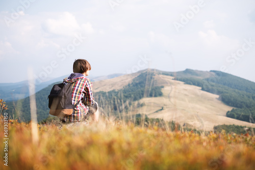 Boy with backpack in autumn mountains . Travel concept. Landscape photography