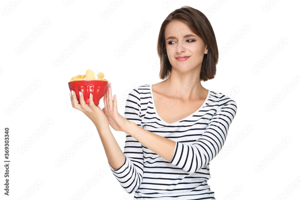 Beautiful young woman holding potato chips in bowl on white background Beautiful young woman holding potato chips in bowl on white background