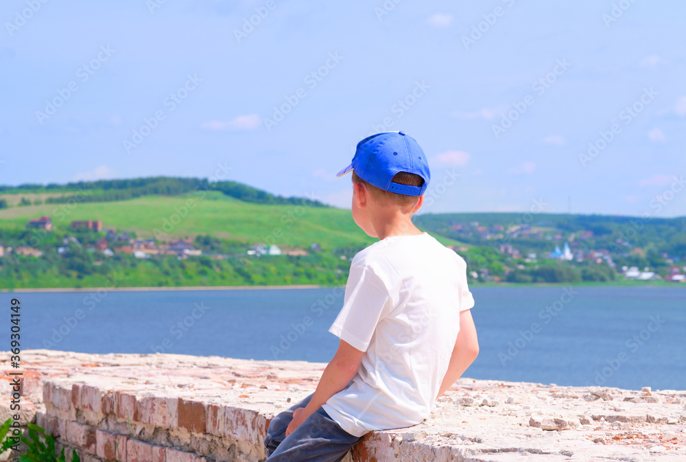 young boy on the beach. travel in 2020. Sea view. hot summer day