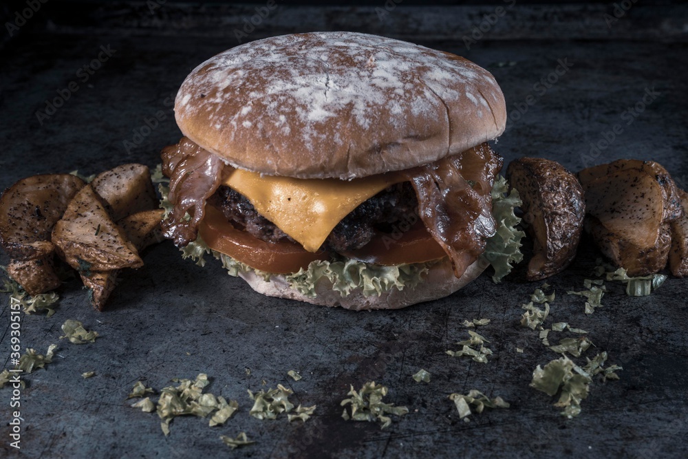 Tasty burger on rustic background Tasty burger on rustic background