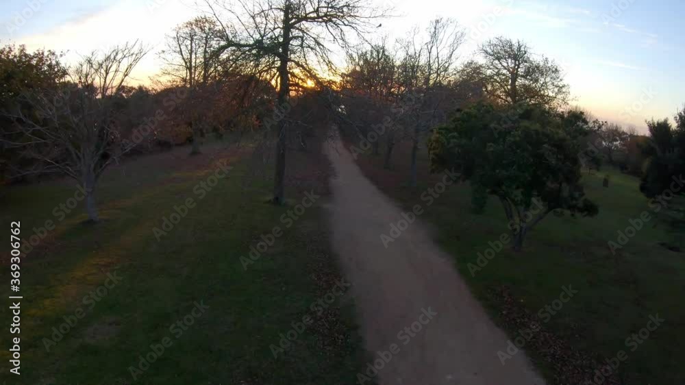 Forward FPV flight rising high up revealing ocean at sunset with dynamic turns Forward FPV flight rising high up revealing ocean at sunset with dynamic turns