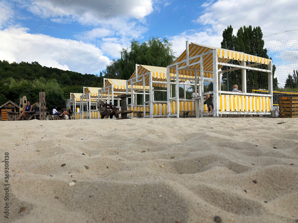 yellow and white striped beach cabanas