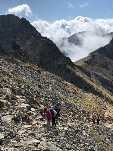 hikers on a very steep mountain path photo