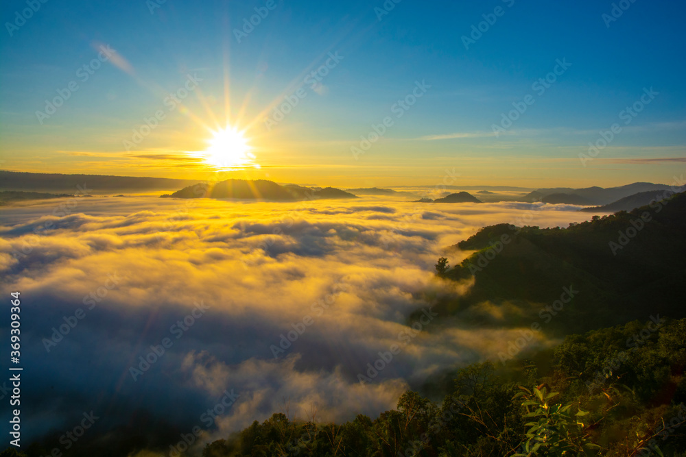 Beautiful landscape in the mountains at sunrise with mist and fog sunrays at mekong River Thai-Laos border Nong Khai province,Thailand. (selective focus and white balance shifting applied).
