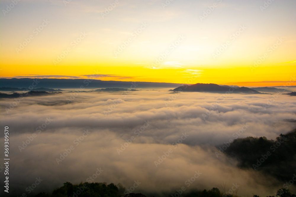 Beautiful landscape in the mountains at sunrise with mist and fog sunrays at mekong River Thai-Laos border Nong Khai province,Thailand. (selective focus and white balance shifting applied)