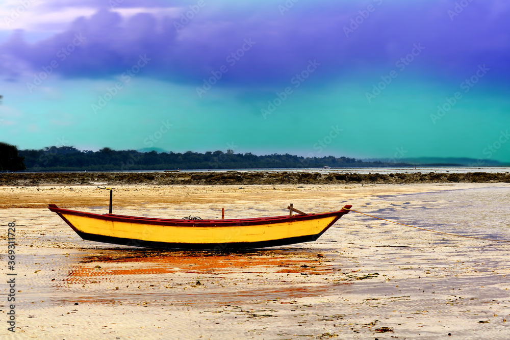 Yellow colored boat on the beach of Henrys Island, Andaman, India Yellow colored boat on the beach of Henrys Island, Andaman, India