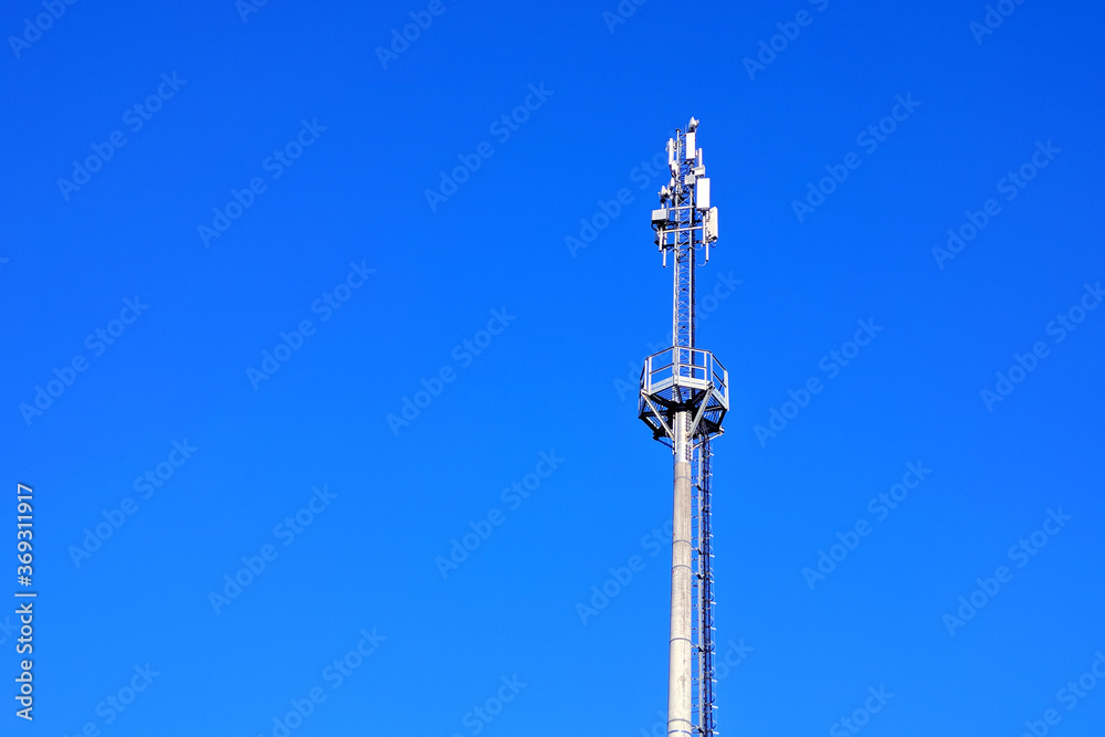 A large Internet tower against a blue sky