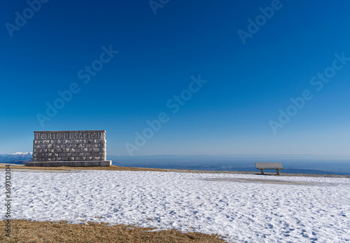 Panorama from Cima Grappa with commemorative wall with  Porte di Salton  writing and empty bench. The Military Shrine of Cima Grappa is one of the main military ossuaries of the First World War