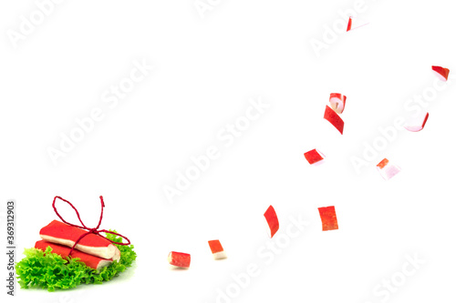 Red crab sticks of surimi on green lettuce with tie and slices i