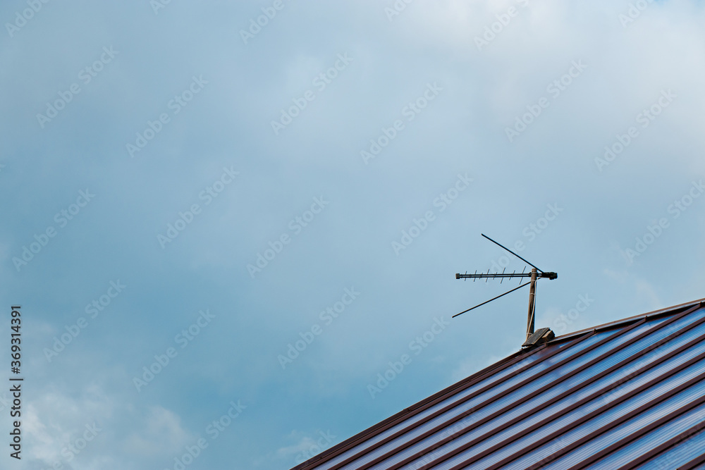 Fototapeta premium Top view with blue sky cloud and antenna. Part of roof with one antenna with copy space. Minimal think. Minimal thing. Conceptual minimalism. Conceptual photography
