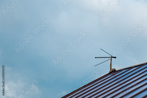 Top view with blue sky cloud and antenna. Part of roof with one antenna with copy space. Minimal think. Minimal thing. Conceptual minimalism. Conceptual photography