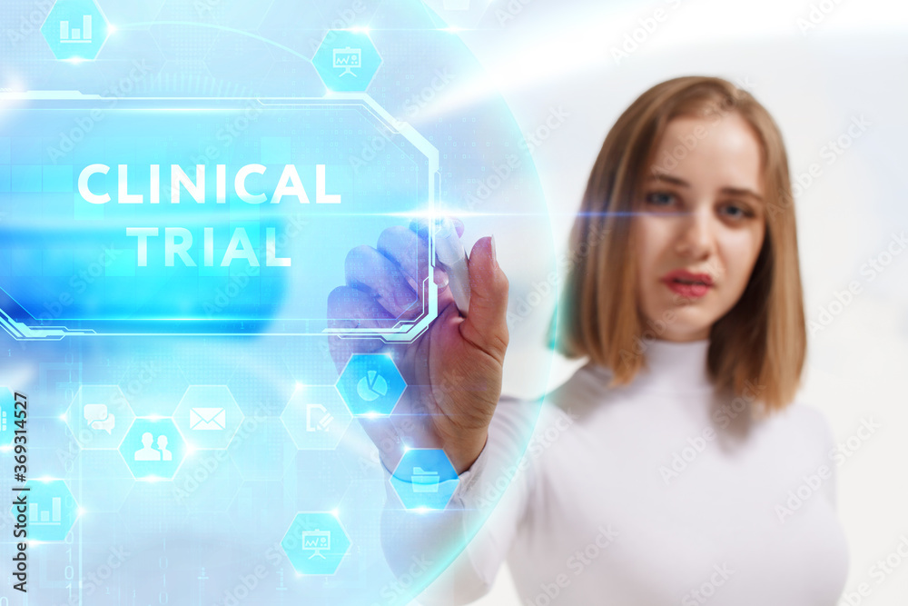 Business, Technology, Internet and network concept. Young businessman working on a virtual screen of the future and sees the inscription: Clinical trial Business, Technology, Internet and network concept. Young businessman working on a virtual screen of the future and sees the inscription: Clinical trial