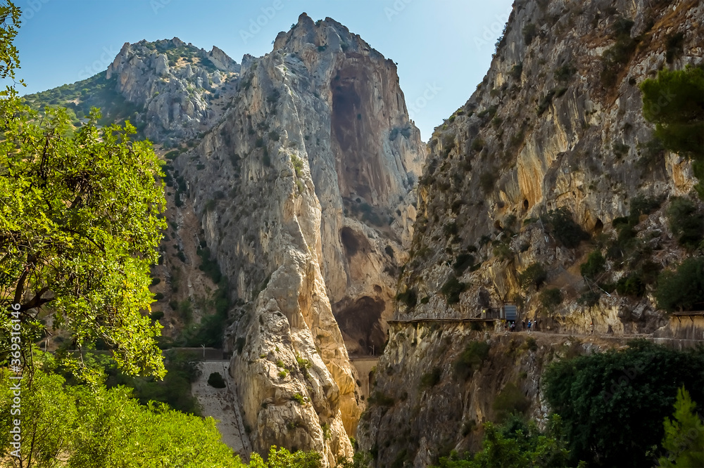 Obraz premium The Caminito del Rey pathway approaches the narrowest section of the Gaitanejo river gorge near Ardales, Spain in the summertime
