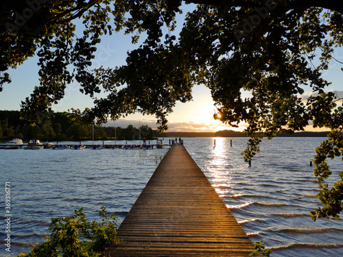 wooden pier at sunset at a lake in brandenburg  photo