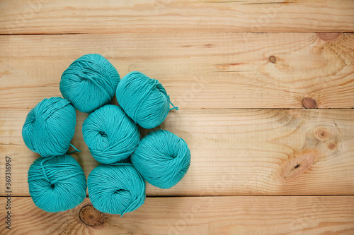 Balls of knitting yarn on wooden background. With Copy Space.