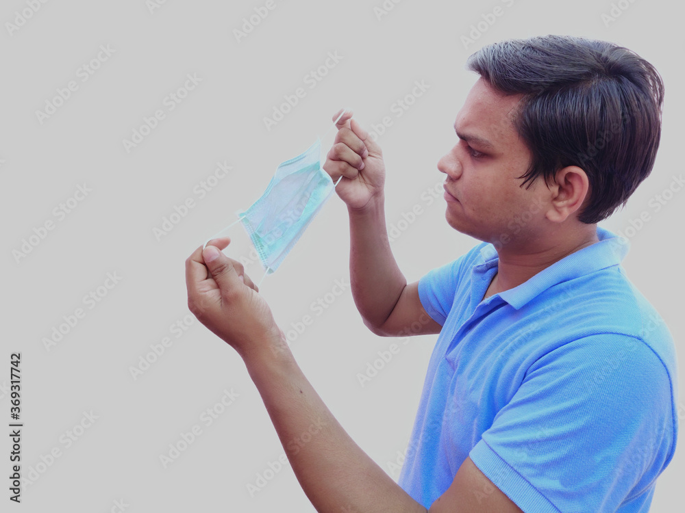 man holding face mask in hand going to wear for protection against corona virus