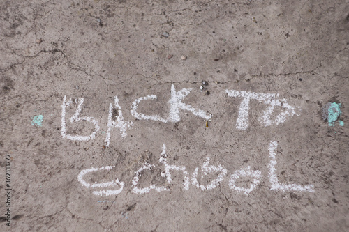 Back to school banner. Word written by colorful chalk. Child drawings. 