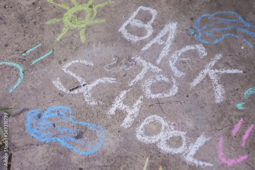 Back to school banner. Word written by colorful chalk. Child drawings. 