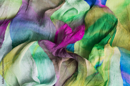 Horizontal background with multicolored wrinkled fabric structure.  Rainbow color cloth for fashion design
